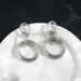 Interlocking titanium steel earrings, elegant banquet style, versatile high-end earrings for women in 2023_ipsvogv.com