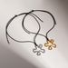 Spot INS Gold Plated Titanium Steel Retro Geometric Hollow Camellia Flower Black Leather Rope Necklace_ipsvogv.com
