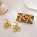 Unisex New Three Dimensional Ripple Bow Retro Earrings Copper Crossing Bow Sweet Ear Hook Light Luxury Temperament Earrings_ipsvogv.com