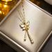 Cat's Eye Bow Tassel Titanium Steel Necklace High end Light Luxury Micro Zirconium Embedding 2023 Summer New Style with_ipsvogv.com