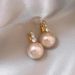 2023 new popular pink pearl earrings female niche design high-grade light luxury French stud earrings_ipsvogv.com
