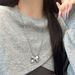 Autumn New Korean Silver-Plated Matte Silver Ribbon Bowknot Dynamic Pearl Necklace Sweater Chain For Women With High-End_ipsvogv.com