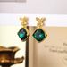 Qingdao jewelry emerald crystal micro inlaid zircon butterfly ethnic style women's earrings niche high-end feeling_ipsvogv.com