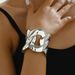 Light luxury style women's wristband with personalized inlaid pearls adjustable opening, featuring a niche flower design_ipsvogv.com
