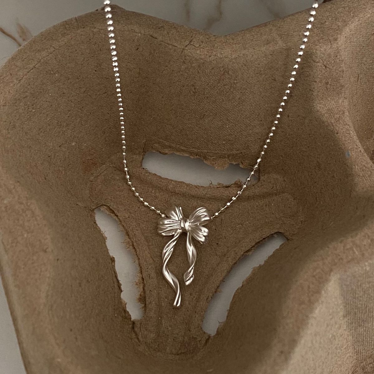 Brass Electroplated Thick Silver Ribbon Bowknot Rice Bead New Simple Niche Design Sense Cool Ins Necklace_ipsvogv.com