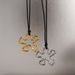 Spot INS Gold Plated Titanium Steel Retro Geometric Hollow Camellia Flower Black Leather Rope Necklace_ipsvogv.com