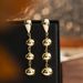 Gold-Plated Copper Minimalist Style Three Glossy Ball Tassel Earrings High-End Creative Round Bead Ear Cuffs For Women_ipsvogv.com