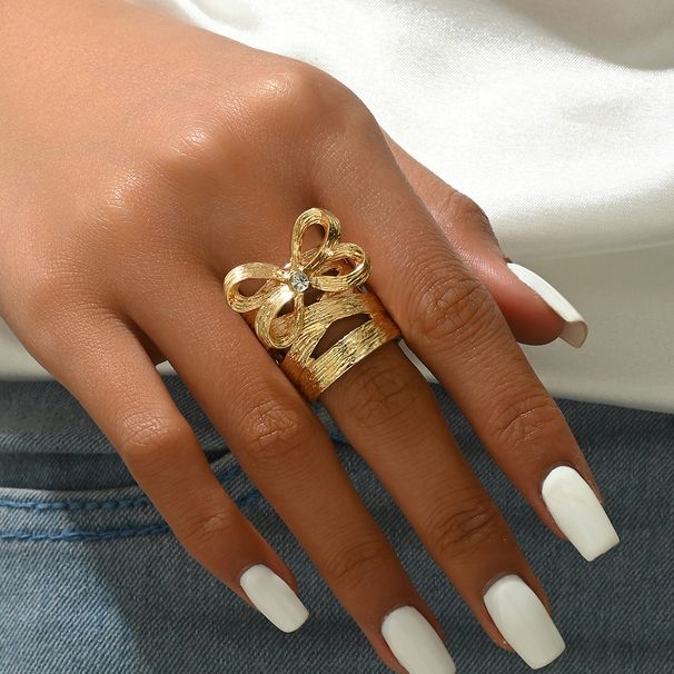 A niche Korean version of copper zircon inlaid with simple bow design women. The ring has an adjustable opening for the_ipsvogv.com