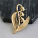 White orange tea, lily of the valley high-end exquisite women's electroplated matte gold brooch, niche design, elegant_ipsvogv.com