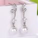 Cao Shi Synthetic Mother Shell Pearl Earrings Elegant and Exquisite Wave Pattern Earrings for Women's Long and Simple Earrings_ipsvogv.com