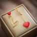 Unisex new creative personality niche asymmetrical hollow love titanium steel hanging earrings_ipsvogv.com